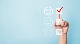 Hand choose to rating score happy icons symbolizing pulse survey for employees