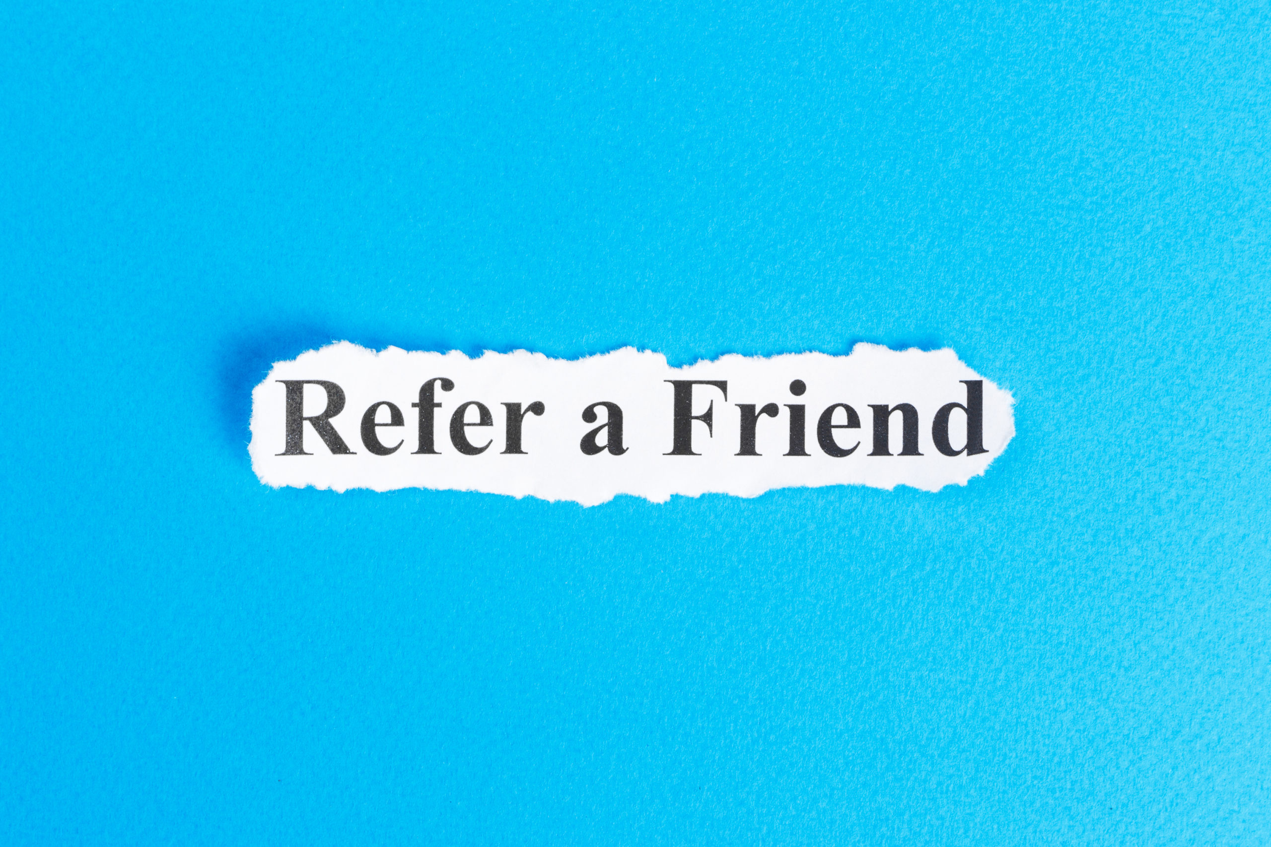Blue background with words "refer a friend" written in text